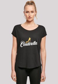 Melns īsām piedurknēm T-krekls ar "Cinderella" baltiem burtiem un zelta augstpapēžu kurpes grafiku priekšā. Mīksta, viegla auduma.