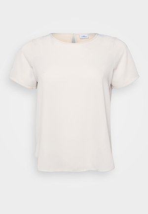 Short-sleeve, round-neck top in light beige fabric with a smooth texture; features a keyhole back detail and relaxed fit.