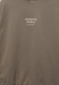 Brown fabric with white text "Authentic Gallery" and smaller locations: Los Angeles, Moreno Valley, Riverside, California.