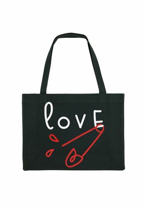 Zwarte canvas totebag met witte en rode tekst die het woord "liefde" uitbeeldt, en een grafisch veiligheidsspeld met rode accenten. Korte hengsels.