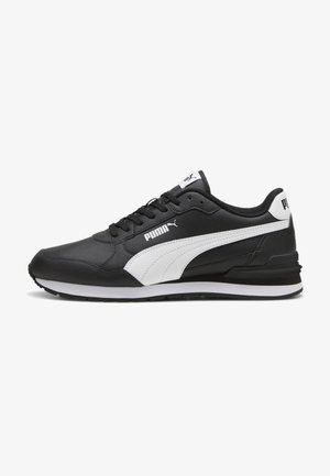 Black athletic shoes made of synthetic leather, featuring a white stripe design, lace closure, and a textured rubber sole.