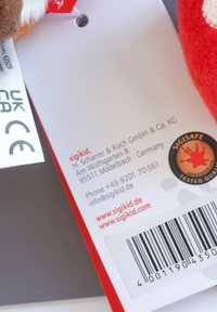Red product tag with white text, featuring a round logo, barcode, and contact details. Material: sturdy paper; design: rectangular shape.