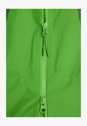 Groen textiel met een gladde textuur, voorzien van een centrale rits in een bijpassende kleur. De hardware omvat een YKK-rits en dubbele trekhangertjes.