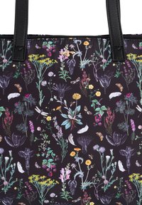 Black fabric tote bag with colorful floral and butterfly print. Features sturdy black handles and a zip closure.
