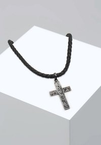 Collana in pelle intrecciata nera con pendente a croce in argento dalla texture, che mostra superfici distinte e una forma geometrica.