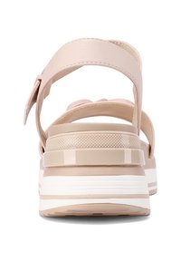 Sandalo beige con cinturini larghi, tacco testurizzato e suola spessa bianca. Presenta una soletta imbottita e una cinghia posteriore regolabile.