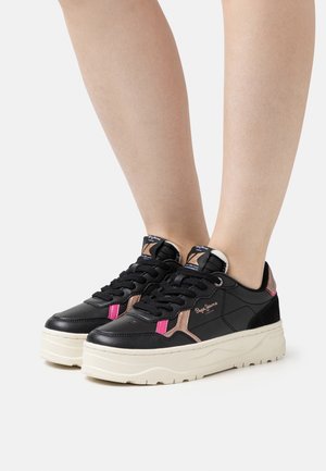 Svarta syntetiska sneakers med en kraftig beige sula, med rosa och beige detaljer på sidorna och en vadderad tunga för komfort.