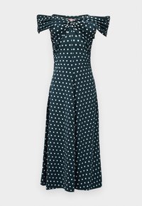 Robe longue noire épaules dénudées avec des pois blancs et un détail torsadé froncé au niveau de la poitrine.