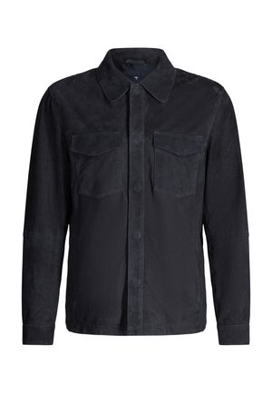 Schwarze Wildlederjacke mit langen Ärmeln, spitzem Kragen, Knopfleiste vorne und zwei Brustklappentaschen.