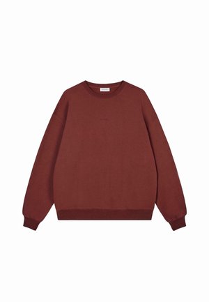 Rust brown long-sleeve crewneck sweatshirt with ribbed cuffs and hem, minimal "OH APRIL" text embroidered on the chest.