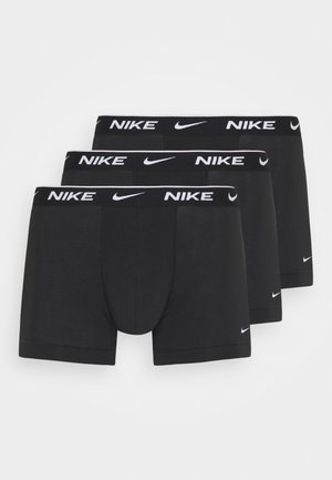 Mustad mustad päevad mustad aluspüksid kolme komplekti. Valmistatud sileda kangaga, millel on lame vöökoht ja valge "NIKE" logo ning väikesed brändi aktsendid.