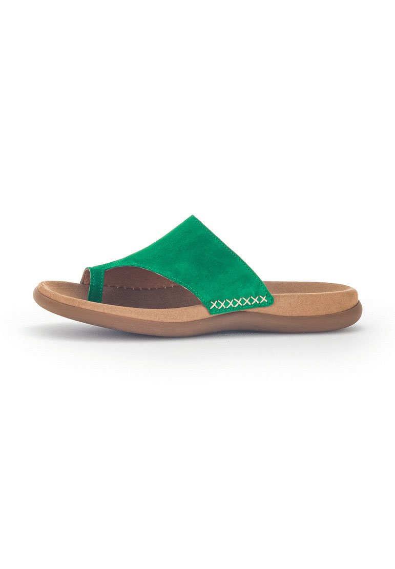 Green suede slide sandal with a toe opening, brown cushioned sole, and contrasting stitching detail on the side. Flat design for easy wear.