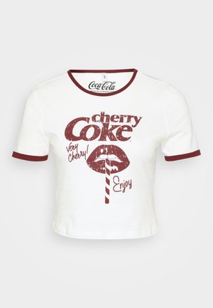 White cropped t-shirt with a round maroon neckline and sleeve hems. Features retro red graphic text stating "cherry Coke" and a lip illustration.