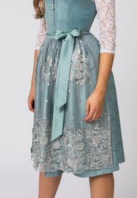 Teal dirndl dress with lace sleeves, a fitted bodice, and a gathered skirt featuring silver floral embroidery and a matching ribbon belt.