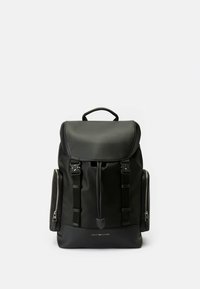 Black backpack made of synthetic material. Features a top flap, adjustable straps, side zippers, and logo on the front panel.