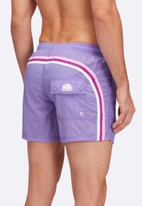 Pantaloni da nuoto viola con strisce laterali bianche, rosa e rosa scuro. Include una tasca posteriore con un logo e un dettaglio in occhio di bue.