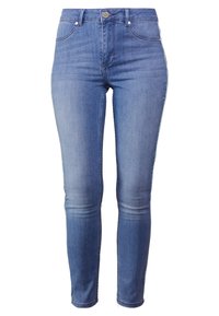 Blå denim skinny jeans med hög midja, klassisk femficksdesign och subtila slitningar på låren. Lätt struktur och figurnära passform.