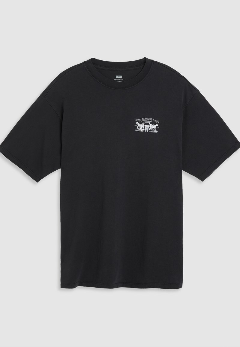 Camiseta de algodón negra de manga corta, cuello redondo y un pequeño estampado gráfico blanco en el pecho con un diseño estilizado.