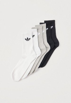 Ensemble de cinq chaussettes montantes en blanc, gris et noir. Texture côtelée avec un petit logo noir sur chaque chaussette. Hauteur standard pour un port décontracté.