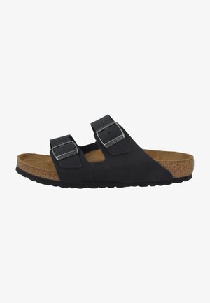 Black sandals with two adjustable straps, metal buckles, and a cork footbed. Textured rubber sole for grip and comfort.