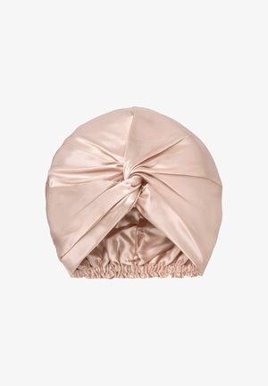 Lichtroze satijnen haarturban met een knoop aan de voorkant en een elastische band aan de basis voor een stevige pasvorm.