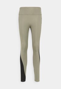 Legginsy w oliwkowym kolorze z bezszwowym wzorem, z czarnym akcentem po bokach. Wykonane z elastycznej, gładkiej tkaniny. Wysoki stan.