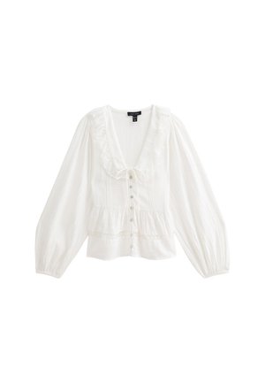 Blouse blanche à manches longues avec décolleté en V froncé, fermeture à boutons sur le devant, taille peplum et poignets lâches et froncés.