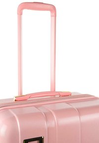 Maleta rígida rosa con superficie texturada, mango retráctil y detalles en dorado. Cuenta con un asa superior y un cierre de cremallera.