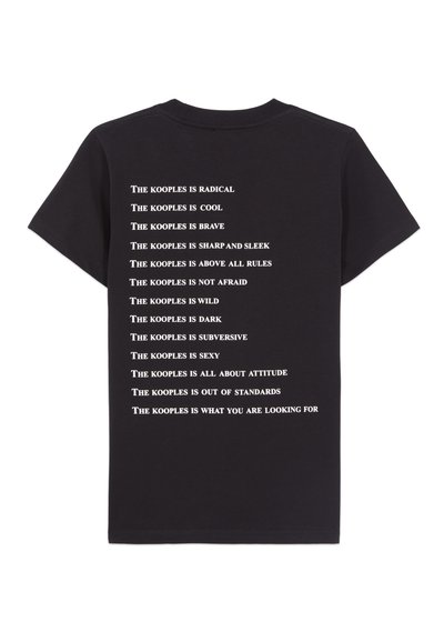 Black cotton T-shirt featuring white text on the back, listing attributes associated with "The Kooples" in a bold, minimalist style.