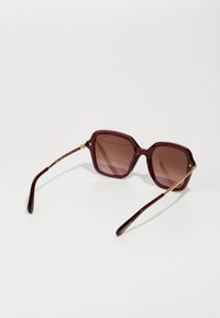 Swarovski Ochelari de soare - transparent burgundy