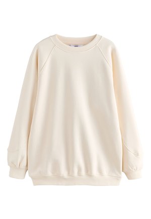 Sweatshirt à manches longues de couleur crème avec col rond, poignets et ourlet côtelés, doté de manches raglan et d'une coupe décontractée.
