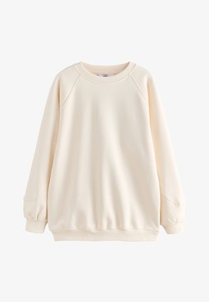Sweatshirt à manches longues de couleur crème avec col rond, poignets et ourlet côtelés, doté de manches raglan et d'une coupe décontractée.