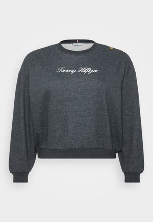 Sweatshirt cinzento cropped com mangas longas, apresentando "Tommy Hilfiger" bordado em branco e botões dourados no ombro. Material em mistura de algodão.