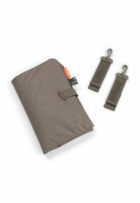 Valkoinen tausta, jossa on taiteltu harmaa vaihtoalusta, jossa on napilla suljettu malli ja kaksi irrotettavaa koukkihihnaa.