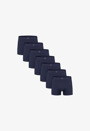 Seven pairs of dark blue men's boxer briefs arranged in a diagonal line on a white background.