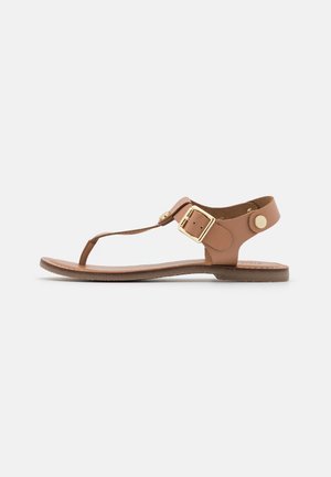 Brown leather sandals with a T-strap design, adjustable buckle closure, and flat sole. Smooth texture with gold-tone hardware accents.