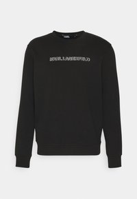 Felpa nera con la scritta "KARL LAGERFELD" ricamata in bianco sul petto. Collo rotondo classico e polsini e orlo a coste.