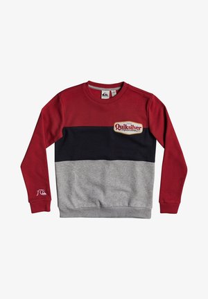 Sweat-shirt à manches longues avec des blocs de couleurs rouge, noir et gris, et un patch logo Quiksilver sur la poitrine et la manche.
