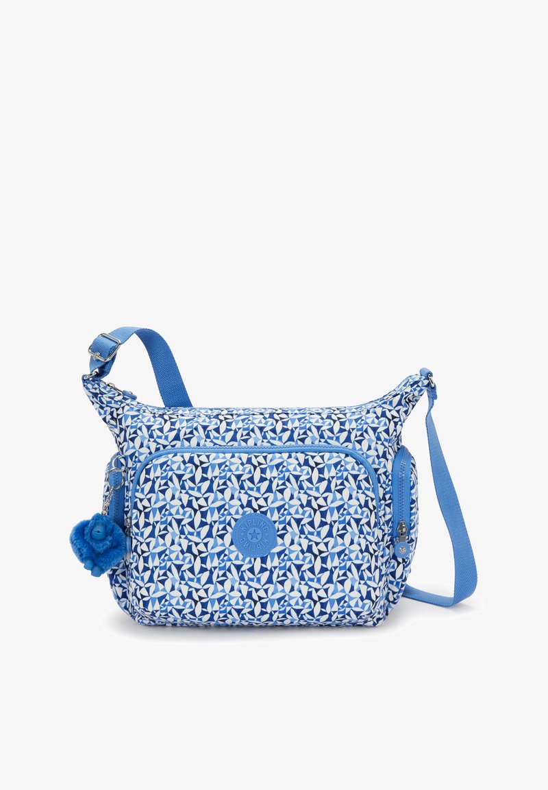 Sininen kuvioitu olkalaukku, jossa on vetoketjullinen etutasku, säädettävä hihna ja pörröinen sininen pom-pom koriste. Valmistettu kestävästä kankaasta.