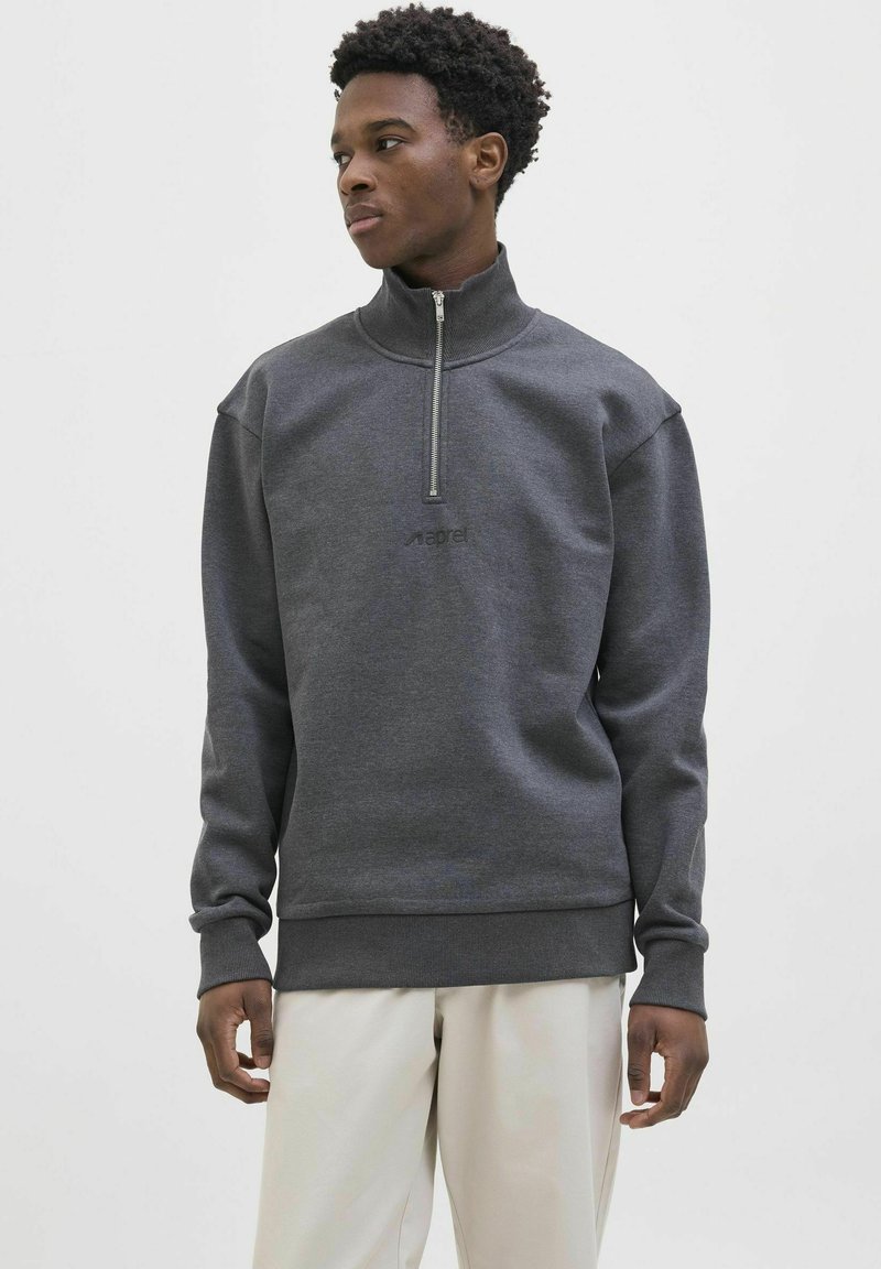 Dark gray quarter-zip pullover with a soft texture, ribbed cuffs and hem, featuring a subtle logo on the chest.