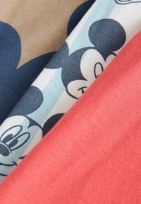 Three pieces of fabric in colors: beige, pale blue with a Mickey Mouse pattern, and coral. The textures are smooth and slightly stretchy.