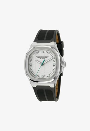 Silberne Armbanduhr mit einem sechseckigen weißen Zifferblatt, schwarzem Gummiband und einem strukturierten Gehäuse. Verfügt über einen grünen Sekundenzeiger und das Aston Martin-Logo.