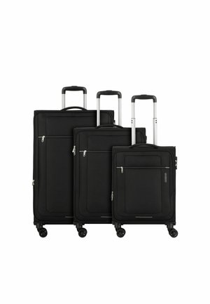 Three black suitcases in varying sizes, made of fabric with smooth texture, featuring zippered pockets and retractable metal handles.