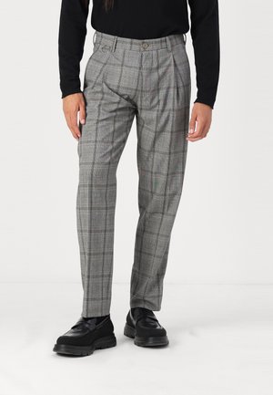 Gray plaid trousers with a tailored fit, featuring a high waist, two front pleats, and side pockets. Worn with black loafers.