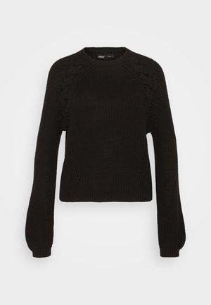 Schwarzer Strickpullover mit Rundhalsausschnitt, langen Ärmeln und filigranen Spitzenverzierungen an den Schultern. Strukturierter Stoff und gerippte Bündchen.