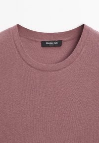 Pink knit sweater featuring a rounded neckline and ribbed cuffs. Label reads "Massimo Dutti," with a soft, smooth texture throughout.
