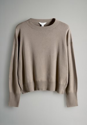 Beige neulepaita, valmistettu pehmeästä materiaalista, jossa on resoroitu pyöreä pääntie, leveät hihat sekä resoroidut hihansuut ja helma.