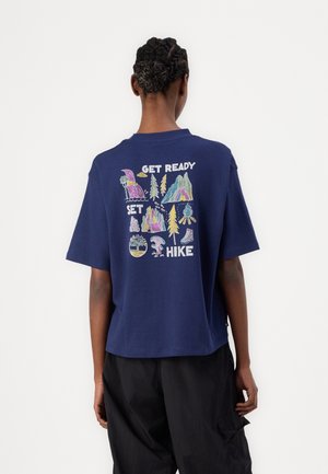 Navy blue cotton T-shirt featuring a colorful outdoor-themed graphic on the back with the text "GET READY SET HIKE." Short sleeves, relaxed fit.
