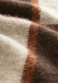 Checkered wool fabric with light beige, brown, and dark brown tones, featuring a soft texture and fuzzy appearance throughout.