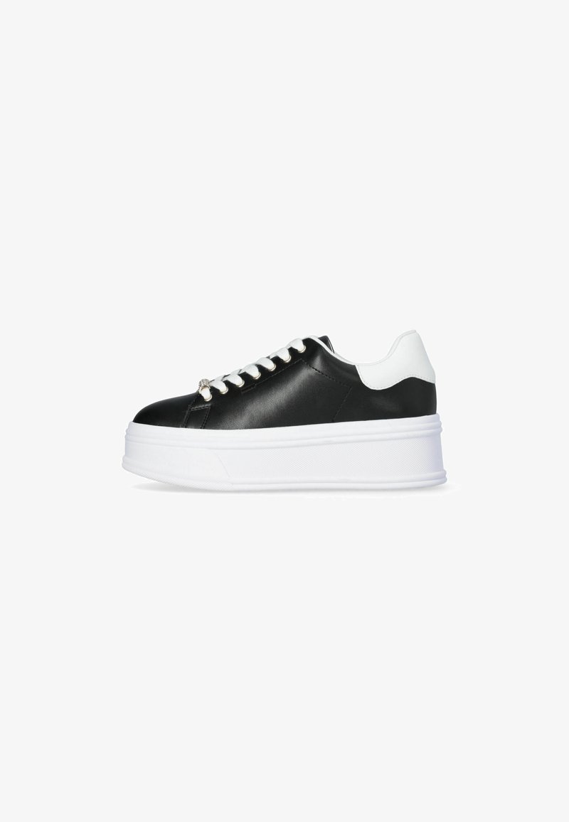 Zwart-witte platform sneakers van synthetisch materiaal, met een ronde neus, platte witte veters en een gestructureerde zool.